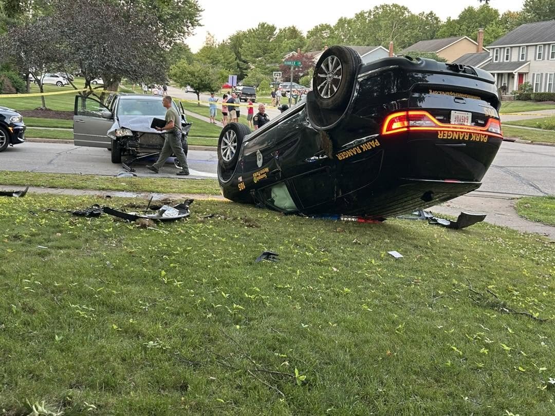 A Summit County Metro Parks cruiser lies overturned at Saybrook Boulevard and Bunker Lane after the suspect struck it. Photo Source: Stow Police Department Facebook page.